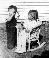 1940 ? Charles Fisher, sister Doris Fisher in wicker rocker - cropped
