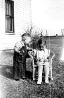 1940 Charles and Doris in wicker rocker with little dolls