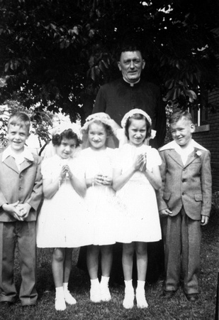 Fr. Noonan’s First Communion Class - Willie Wiedmaier, ? McManus, Unk, Rhonda Buhman, Charlie Fisher.